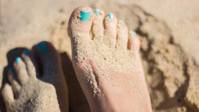 Feet in sand.
