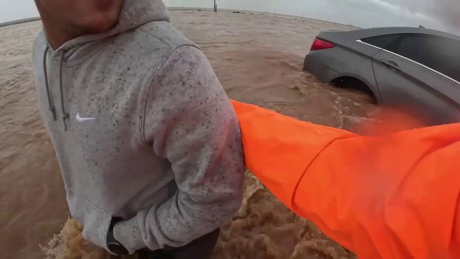 Dramatic moments unfolded on camera Thursday as a storm chaser helped a young man in need while his car began to float away. It happened on impassable Highway 87 near O'Donnell and south of Lubbock.