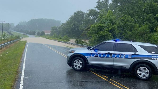 A police cruiser blocks a flooded road in Kannapolis, North Carolina, on June 20, 2023.