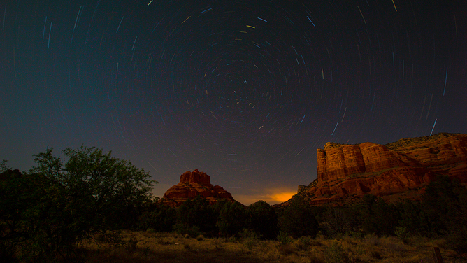 FILE - A 20 minute time exposure showing Red Rock Butte and Courthouse Butte just north of the Village of Oak Creek, Arizona, south of Sedona in Yavapai County on May 18, 2021.