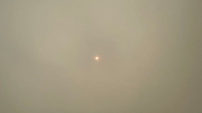 The smoke is nearly covering the sun in the sky in Brick, New Jersey.