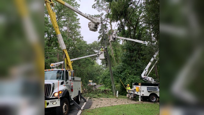 Utility workers repair powerlines in Tallahassee, FL on Thursday, June 15, 2023 after a severe storm caused widespread damage.