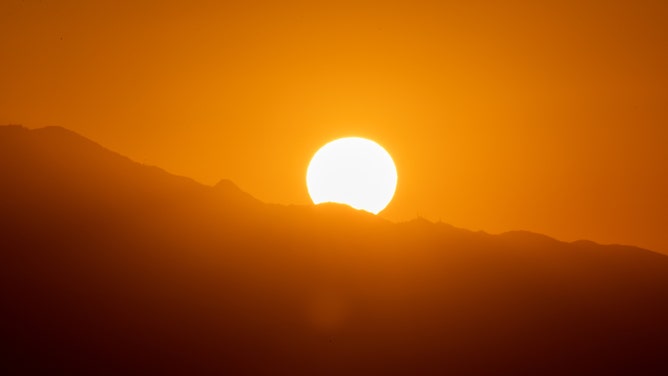 FILE - Sun rises over mountains as seen from the Griffith Observatory in Los Angeles, California, United States on September 3, 2022.