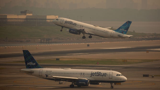 FILE - A JetBlue plane departs LaGuardia Airport (LGA) in the Queens borough of New York, US, on Thursday, June 8, 2023. The Federal Aviation Administration said LaGuardia Airport flights were placed under a ground delay program after being grounded due to poor visibility.