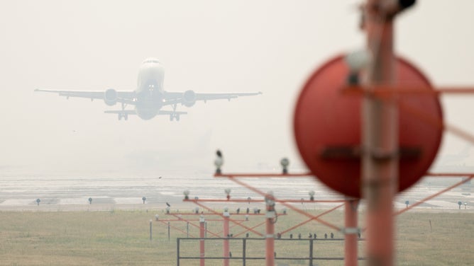 A Delta Airbus A320 airplane takes off from Ronald Reagan Washington National Airport in Arlington, Virginia, on June 8, 2023, as smoke from wildfires in Canada blankets the area. Smoke from Canadian wildfires have shrouded the US East Coast in a record-breaking smog, forcing cities to issue air pollution warnings and thousands of Canadians to evacuate their homes. The devastating fires have displaced more than 20,000 people and scorched about 3.8 million hectares (9,390,005 acres) of land. Prime Minister Justin Trudeau described this wildfire season as the country's worst ever. (Photo by SAUL LOEB / AFP) (Photo by SAUL LOEB/AFP via Getty Images)