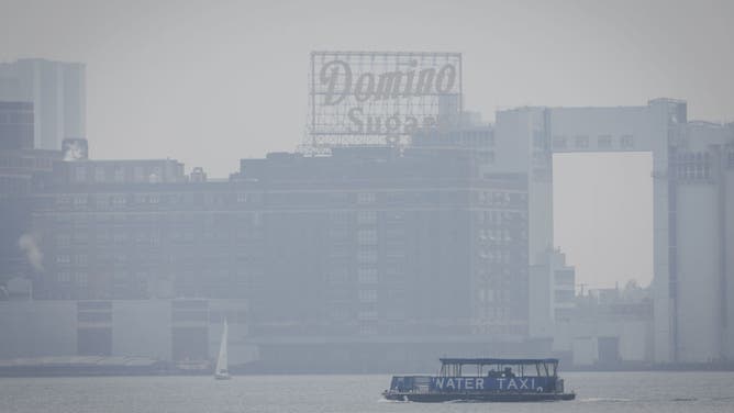 A water taxi at the Inner Harbor as smoke from Canada wildfires blankets Baltimore, Maryland, US, on Thursday, June 8, 2023. The US Northeast will continue to breathe in choking smoke from fires across eastern Canada for the next few days, raising health alarms across impacted areas. Photographer: Ting Shen/Bloomberg via Getty Images