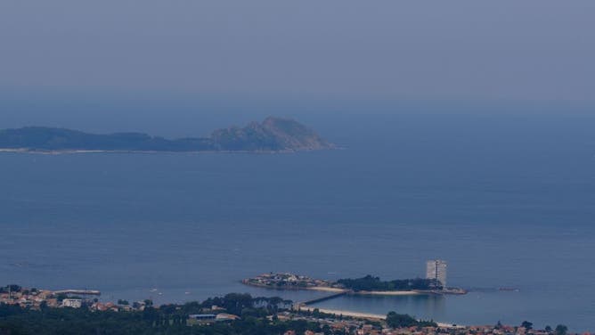 The smoke cloud produced by the multiple wildfires ongoing in Quebec is seen above the sea next to the coast of Vigo, northwestern Spain on June 26, 2023.