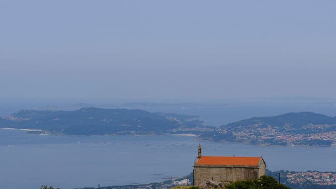 The smoke cloud produced by the multiple wildfires ongoing in Quebec is seen above the sea next to the coast of Vigo, northwestern Spain on June 26, 2023.