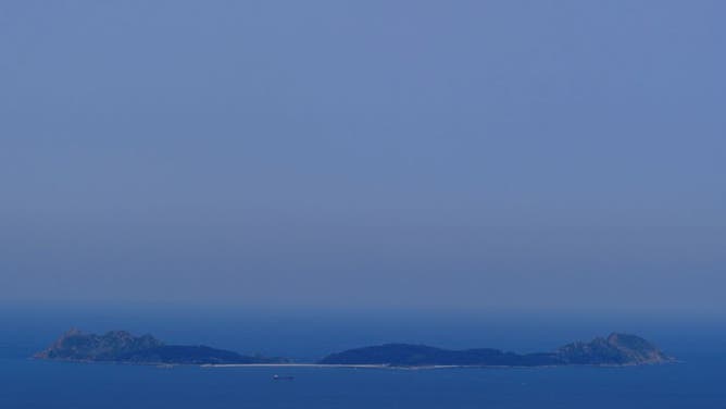 The smoke cloud produced by the multiple wildfires ongoing in Quebec is seen over the Cies Islands next to the coast of Vigo, northwestern Spain on June 26, 2023.