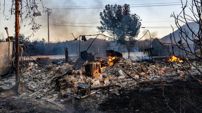 The Juniper fire continues to smolder inside the remains of a home off Santa Rosa Mine Road on June 27, 2023 in Perris, California.The Riverside County fire prompted evacuation orders and threatened multiple structures. (Gina Ferazzi / Los Angeles Times via Getty Images)