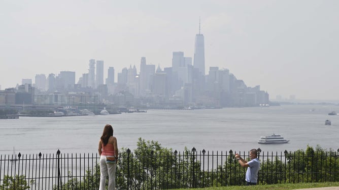 NEW YORK, UNITED STATES - JUNE 29: People carry on with their daily lives as the air quality is at unhealthy levels due to smoke from Canadian wildfires in New York, United States on June 29, 2023. Officials stated that the air quality may worsen in the upcoming days. (Photo by Fatih Aktas/Anadolu Agency via Getty Images)