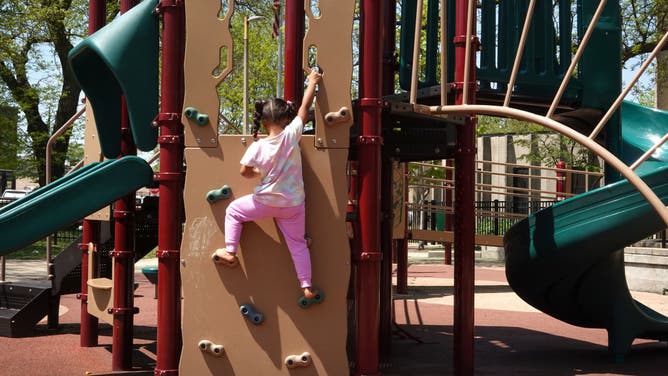 A 5-year-old girl plays on equipment in the playground at Brands Park on May 10, 2023 in Chicago, Illinois.