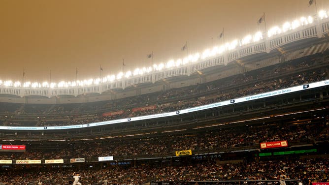 A clearing sky appears over Yankee Stadium after a rain storm moved through  clearing a haze of smoke before a baseball game between the Philadelphia  Phillies and the New York Yankees, Wednesday