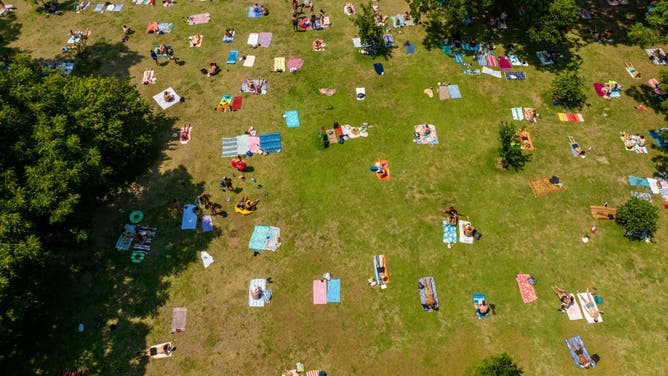 People gather at Barton Springs Pool on June 21, 2023 in Austin, Texas. Extreme temperatures across the state have prompted the National Weather Service to issue excessive heat warnings and heat advisories that affect more than 40 million people.