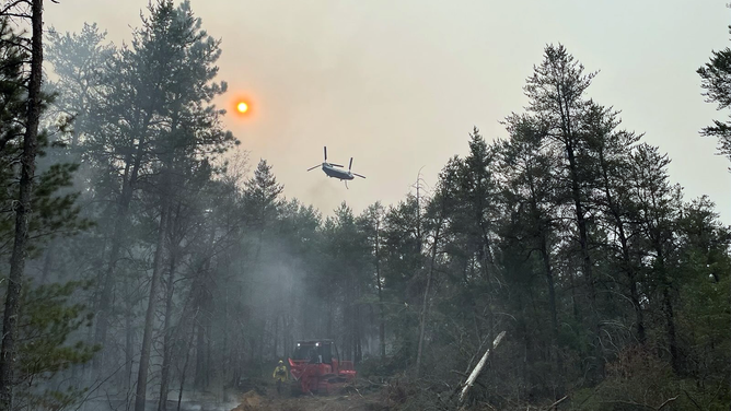 A helicopter is seen helping with fire suppression efforts in Michigan.