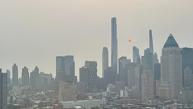 The sun is shrouded in smoke above a hazy New York City skyline Tuesday morning.