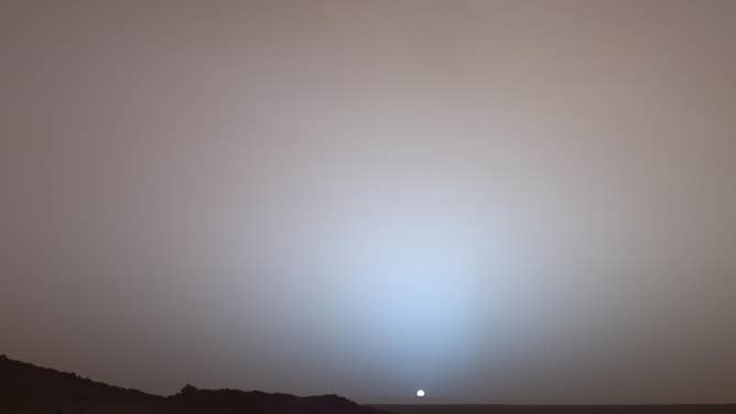 On May 19, 2005, NASA's Mars Exploration Rover Spirit captured this sunset view below the rim of Gusev crater on Mars. 
