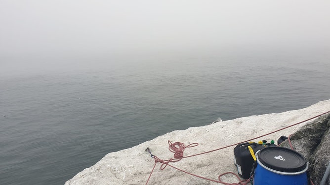 Man's world record endeavor on remote island comes to halt as bad weather forces rescue