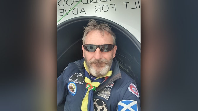 Man's world record endeavor on remote island comes to halt as bad weather forces rescue