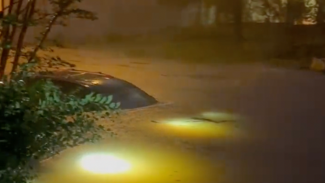 Flooding reaches the roof of a car in downtown Pensacola, Florida. June 16, 2023.