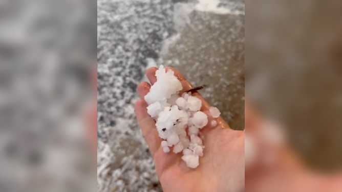 Tiny hail covered the road by a Target parking lot in Lone Tree, Colorado. June 22, 2023.