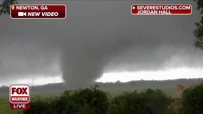 A tornado tears across a field near Newton, Georgia, on June 14, 2023.
