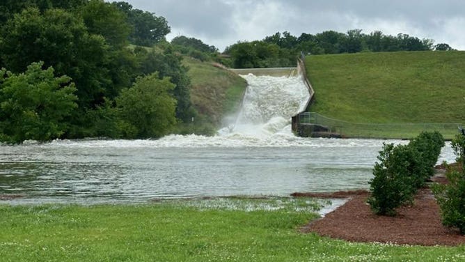 Water flows down the spillway of a dam in Kannapolis, North Carolina, on June 20, 2023.