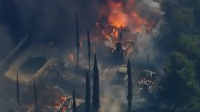 A fast-moving wildfire in Riverside County destroyed several structures and forced evacuations on Tuesday