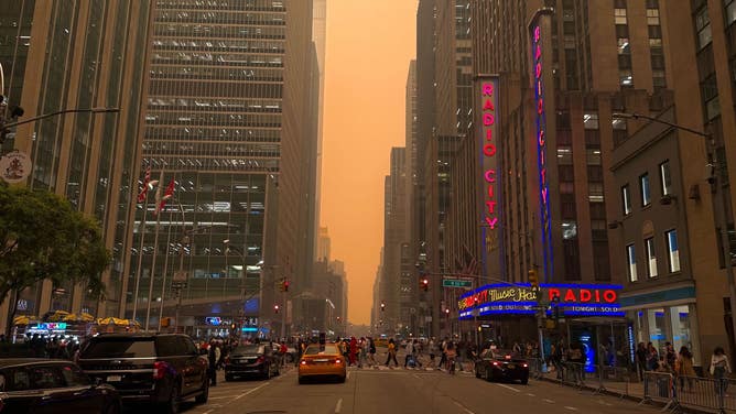Hazy skies with Radio City Music Hall in the foreground. New York City. June 7, 2023.