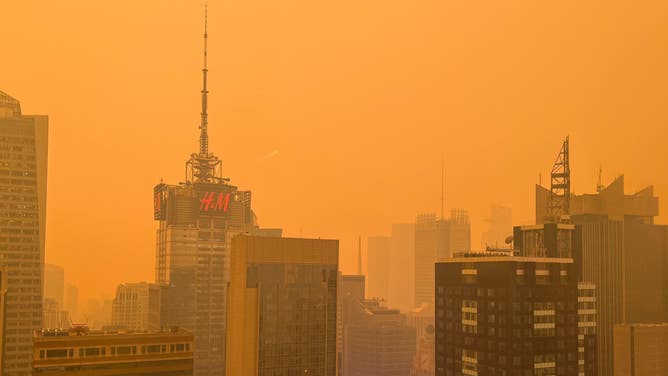 Rust-colored New York City skyline. June 7, 2023.