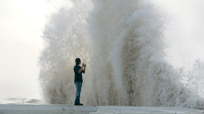 Daniel Gallegos, 26, of Galveston, watches a wave crash into the Seawall on Galveston Island as Hurricane Ike closes on the Texas coast, Friday, September 12, 2008. (Stewart F. House/Fort Worth Star-Telegram/MCT)