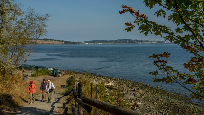 WASHINGTON, UNITED STATES - 2022/10/09: Hikers coming up from the beach at Fort Townsend Historical State Park near Port Townsend, Jefferson County, Washington State, USA. (Photo by Wolfgang Kaehler/LightRocket via Getty Images)