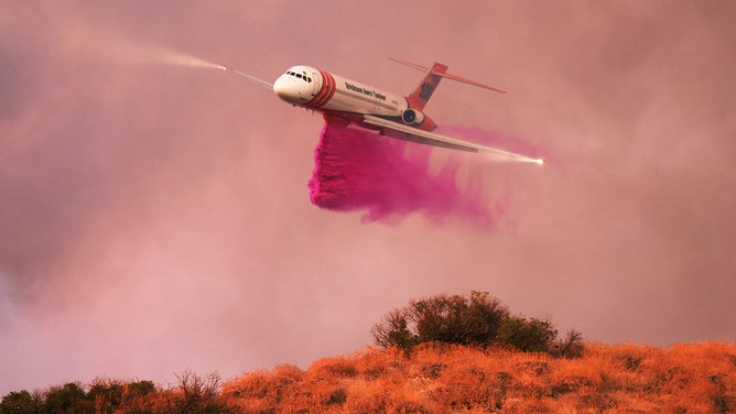 An aircraft drops fire retardant during the Rabbit fire Moreno Valley in Riverside County, Californian on July 14, 2023.