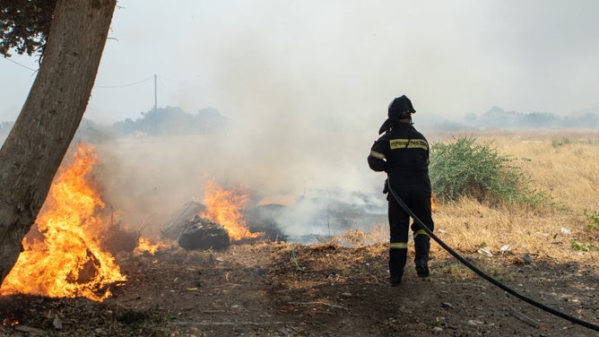 RHODES ISLAND, GREECE - JULY 24: Teams try to extinguish wildfires on Rhodes island, Greece on July 24, 2023. Some 19,000 people have been evacuated from the Greek island of Rhodes as wildfires continued burning for a sixth day, authorities said on Sunday. As many as 266 firefighters and 49 fire engines were on the ground battling the blazes, assisted by five helicopters and 10 airplanes.