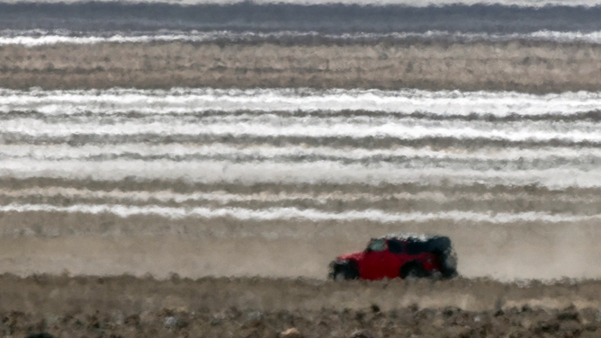 FURNACE CREEK, CALIFORNIA - JULY 16: A Jeep is distorted in the heat haze as the temperature rises past about 127 degrees Fahrenheit on a day that could set a new world heat record in Death Valley National Park on July 16, 2023 near Furnace Creek, California.