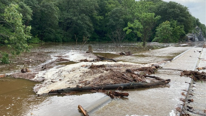 Mud and debris covers railroad tracks in New York state on Sunday, July 9, 2023.