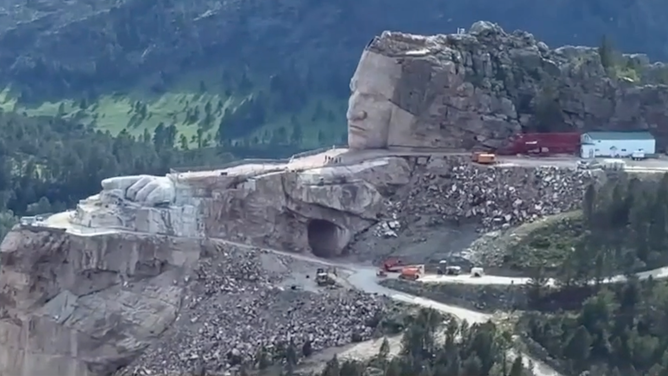 Construction of the Crazy Horse Memorial in South Dakota. Note how his face and left hand are already carved into the mountain.