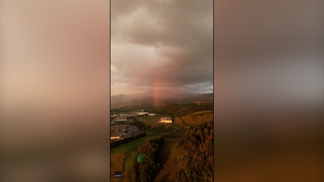 A Virginia-based photographer captured magical footage of a rainbow emerging from the clouds on a rainy July day.