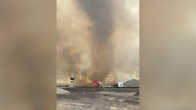 Firefighters are seen trying to contain and extinguish the York Fire burning on the California/Nevada border on July 30, 2023.