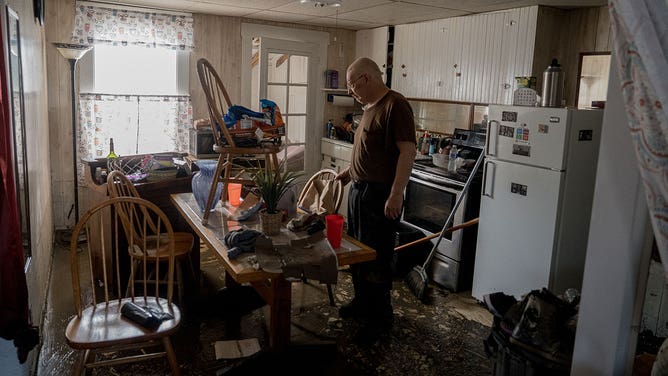 Gordon George, of Barre, Vermont, worked with his daughter, Danielle Palmer, of Washington, to survey the damage to his home caused by flash flooding July 11, 2023.