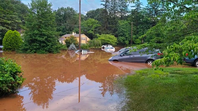 Cars are seen swamped by floodwaters in Lower Makefield Township, Pennsylvania, on July 15, 2023.