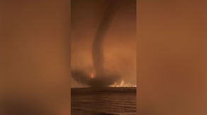 Watch video of waterspout spinning in front of massive Canadian wildfire