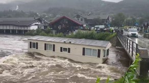 Watch as Norway floodwaters carry away homes, campers and crush them against bridge