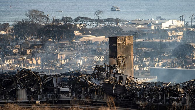 Smoke rises between the remains of Lahaina during the wildfire in Lahaina, Hawaii on August 10, 2023.