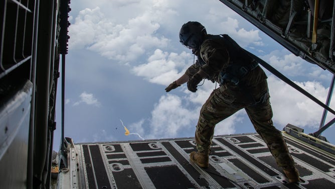 Senior Airman Donny Arseneaux, a loadmaster for the 53rd Weather Reconnaissance Squadron at Keesler Air Force Base, Miss., deploys an Airborne Expendable Bathythermograph from a WC-130J Aug. 5, 2021. The AXBT measures ocean temperature from surface level down to to around 400 meters. (U.S. Air Force by Staff Sgt. Kristen Pittman)