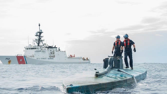 A Coast Guard Cutter Stratton boarding team investigates a self-propelled semi-submersible interdicted in international waters off the coast of Central America, July 19, 2015. The Stratton’s crew recovered more than 6 tons of cocaine from the 40-foot vessel. (Coast Guard photo courtesy of Petty Officer 2nd Class LaNola Stone)