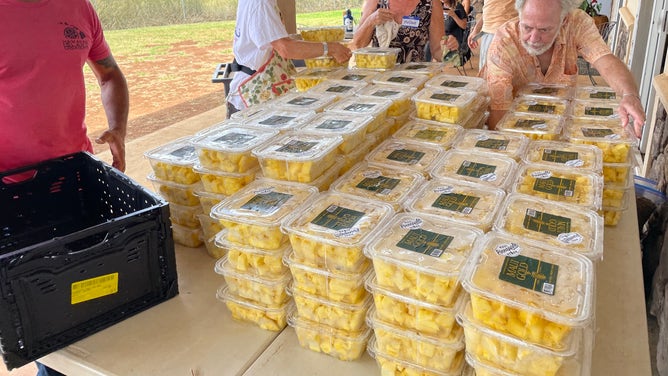 Packaging cut pineapple for delivery.