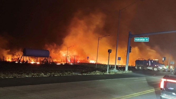 The intersection at Hokiokio Place and Lahaina Bypass is seen Tuesday evening, August 8, 2023, as wildfires burn in Maui County, Hawaii.