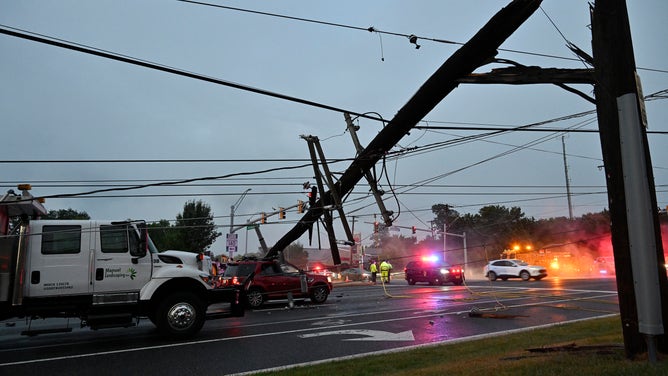 A broken utility pole is seen after powerful thunderstorms moved through Westminster, Maryland, on Monday, August 8, 2023.