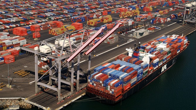 Shipping containers are left stacked in the Port of Los Angeles because of the West Coast lockout of dockworkers by shipping lines on October 2, 2002 in Long Beach, California.